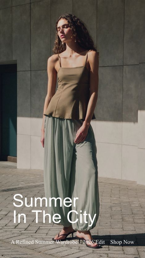 A woman in a sleeveless top and loose pants stands in a sunlit urban setting. Text reads: "Summer In The City."