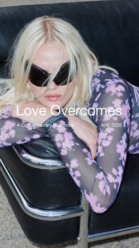 Woman with sunglasses and floral top reclines on a black chair. Text overlay: "Love Overcomes: A Contemporary Wardrobe A/W 2026".