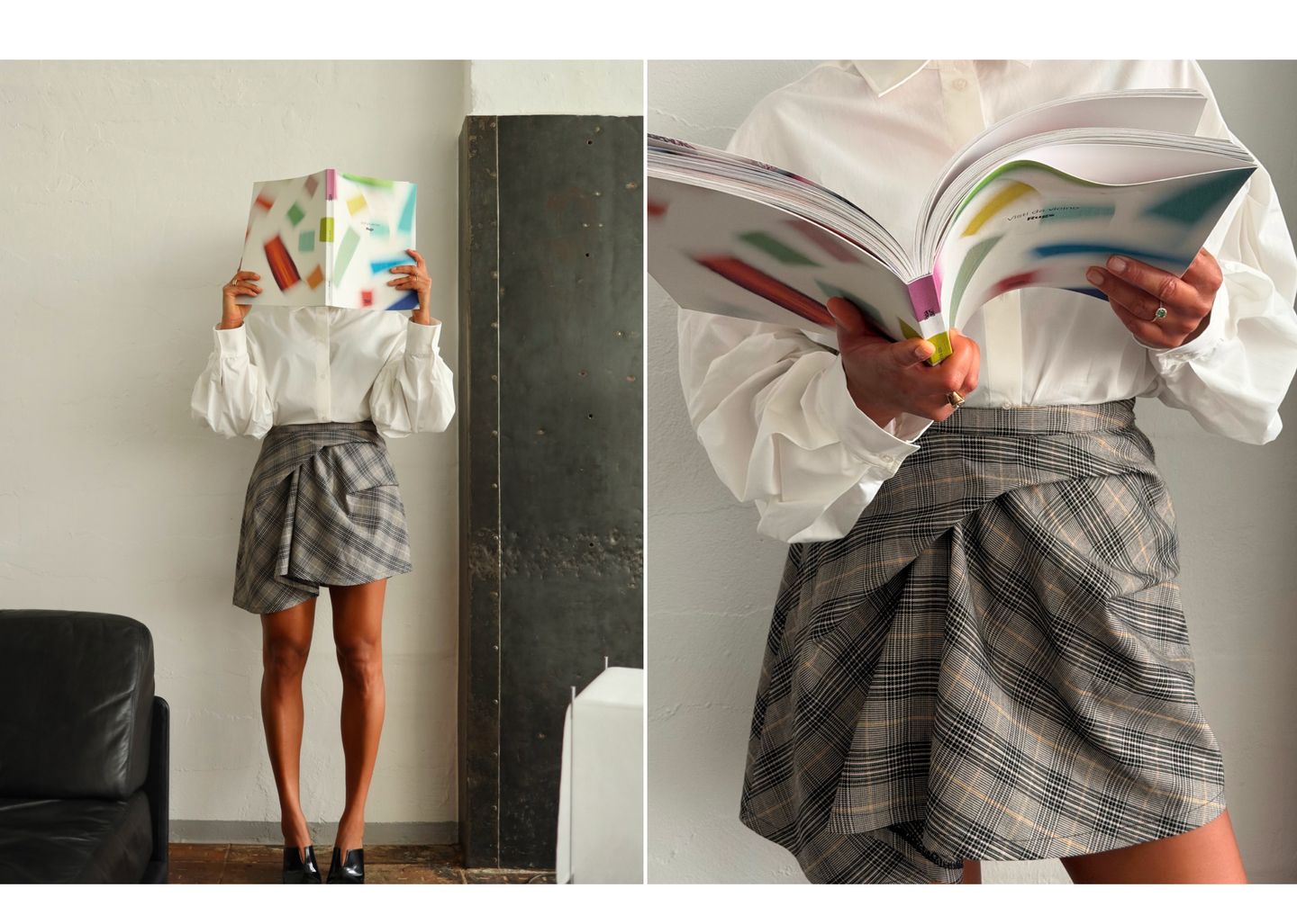 Person in a white shirt and plaid skirt holding a colorful book, obscuring their face. Close-up shows book and outfit details.