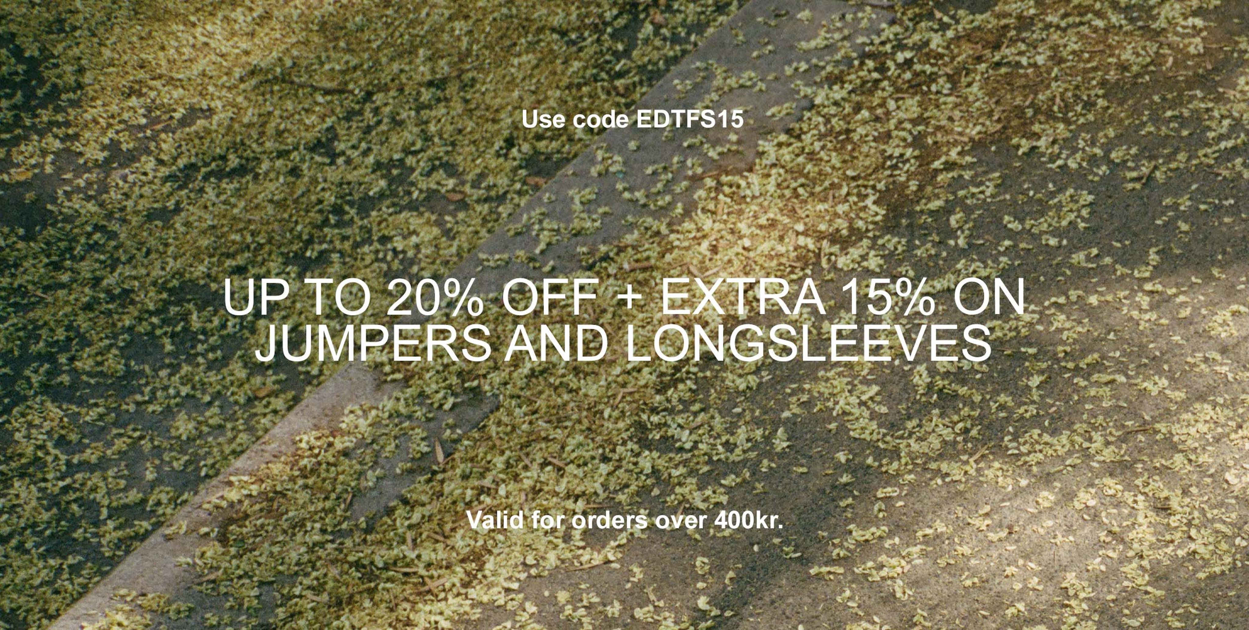 Leaf-covered ground with text offering up to 20% off and extra 15% on jumpers and longsleeves. Use code EDTFS15. Valid for orders over 400kr.