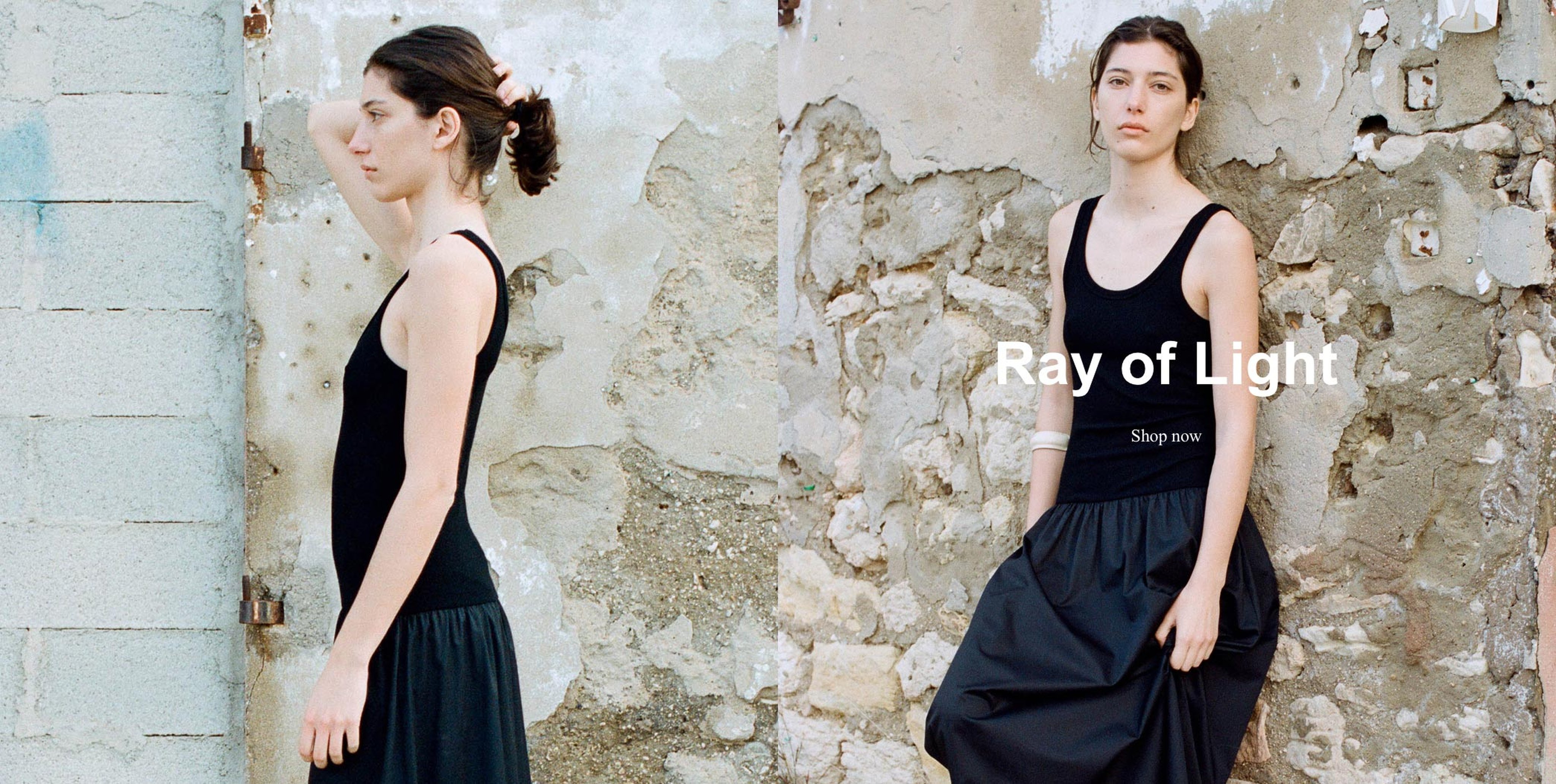 Woman in a black dress poses against a textured, weathered wall. Text reads "Ray of Light, Shop now."