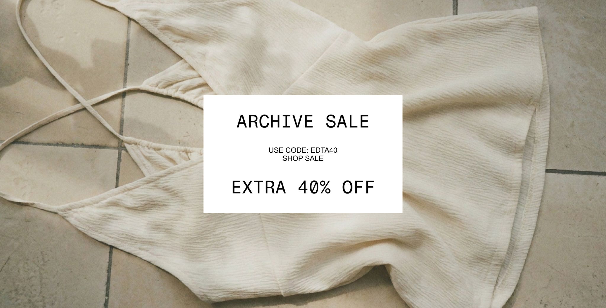 Off-white dress on tile floor with a sale overlay: "ARCHIVE SALE, Use Code: EDTA40, Extra 40% Off".