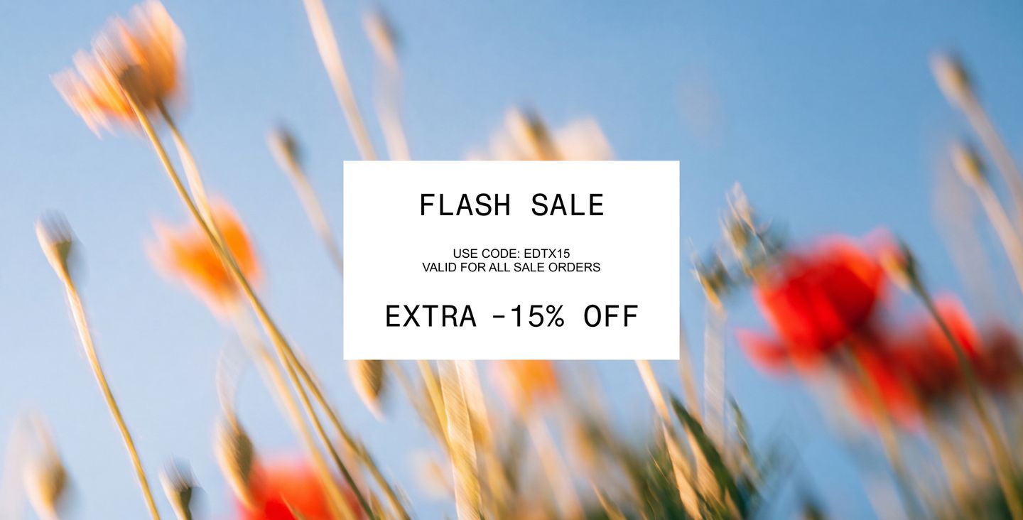 Blurry flowers against a blue sky with a flash sale text overlay. Use code EDTX15 for extra 15% off.