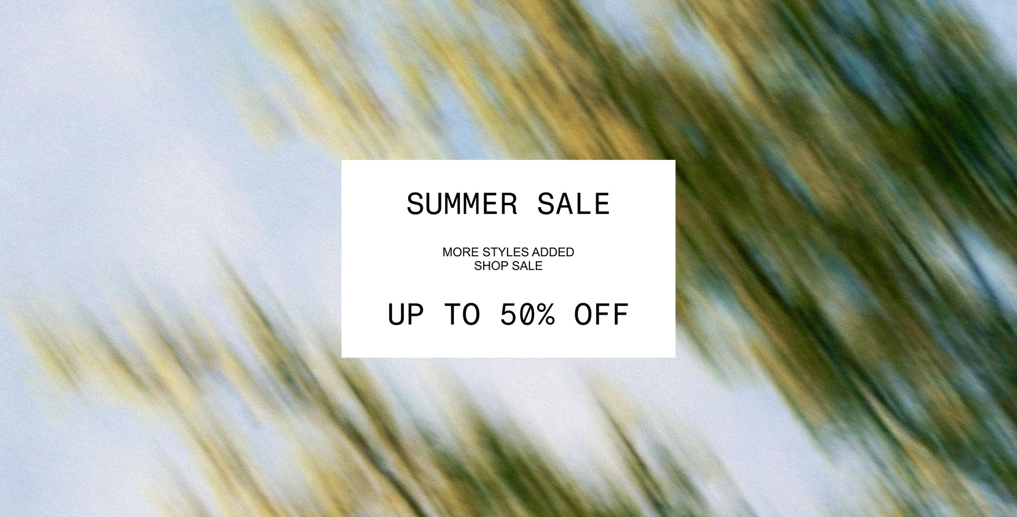 Blurry green and blue background with a white box in the center stating "Summer Sale, Up to 50% Off, More Styles Added, Shop Sale."