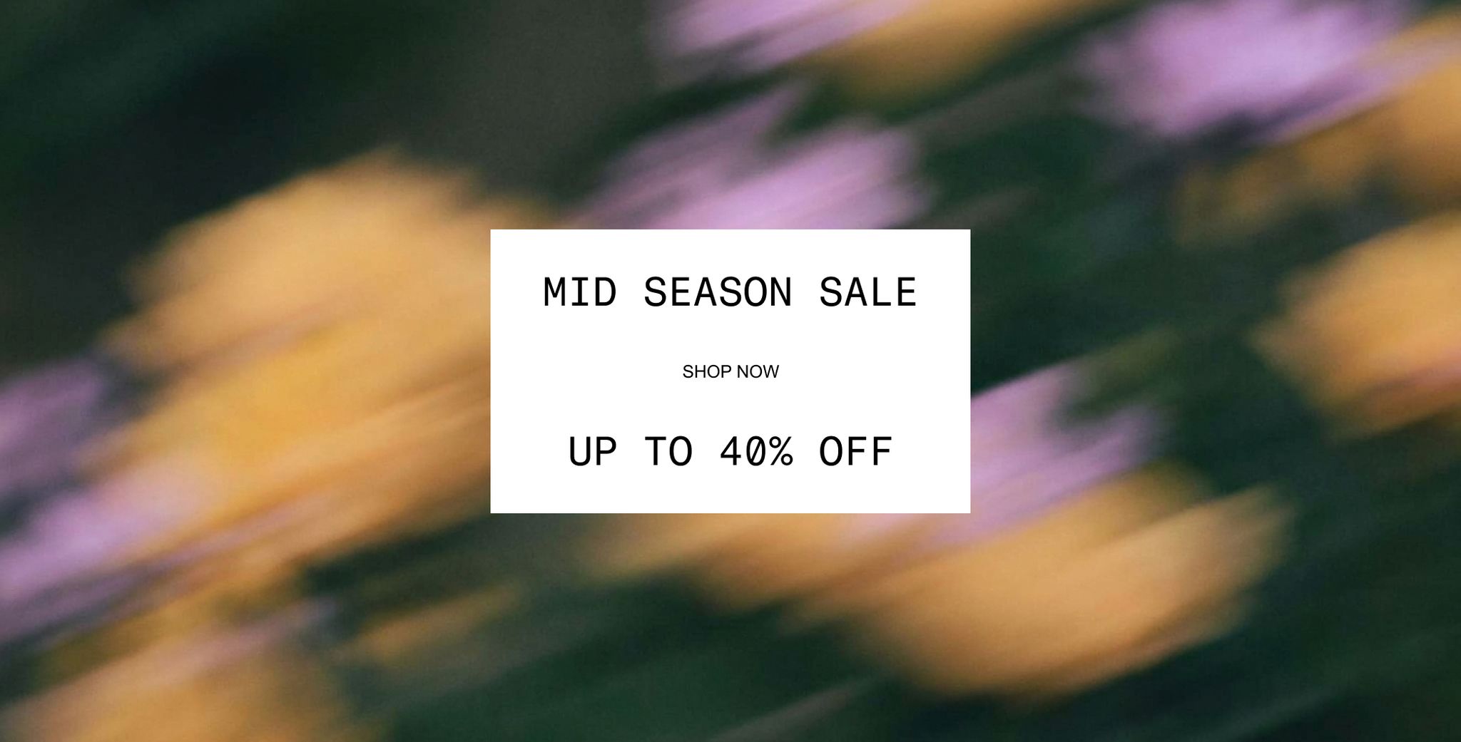 Text in a white box over a blurred floral background reads: "Mid Season Sale. Shop Now. Up to 40% Off".
