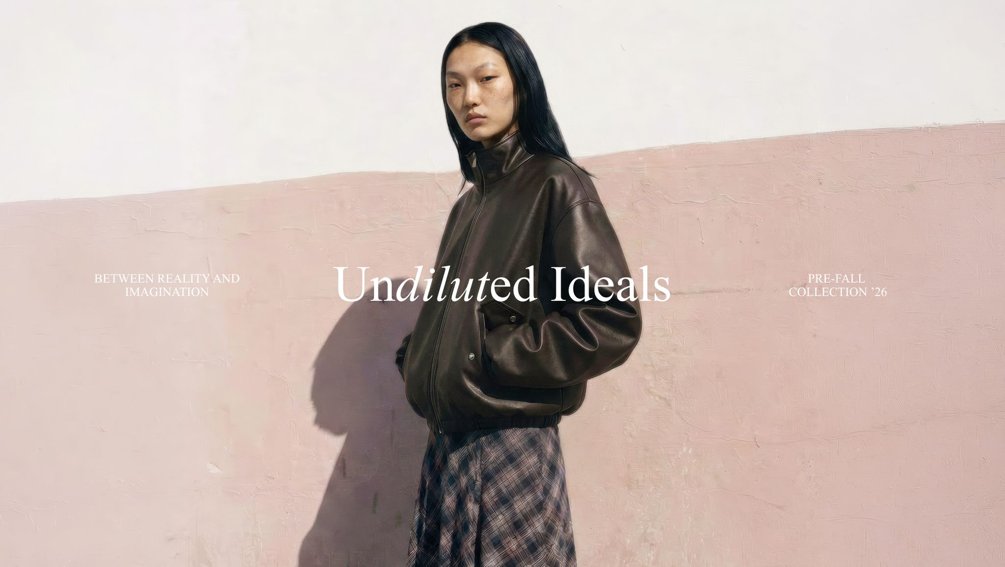A person in a brown leather jacket and plaid skirt stands against a pink wall. Text reads "Undiluted Ideals: Pre-Fall Collection '26."