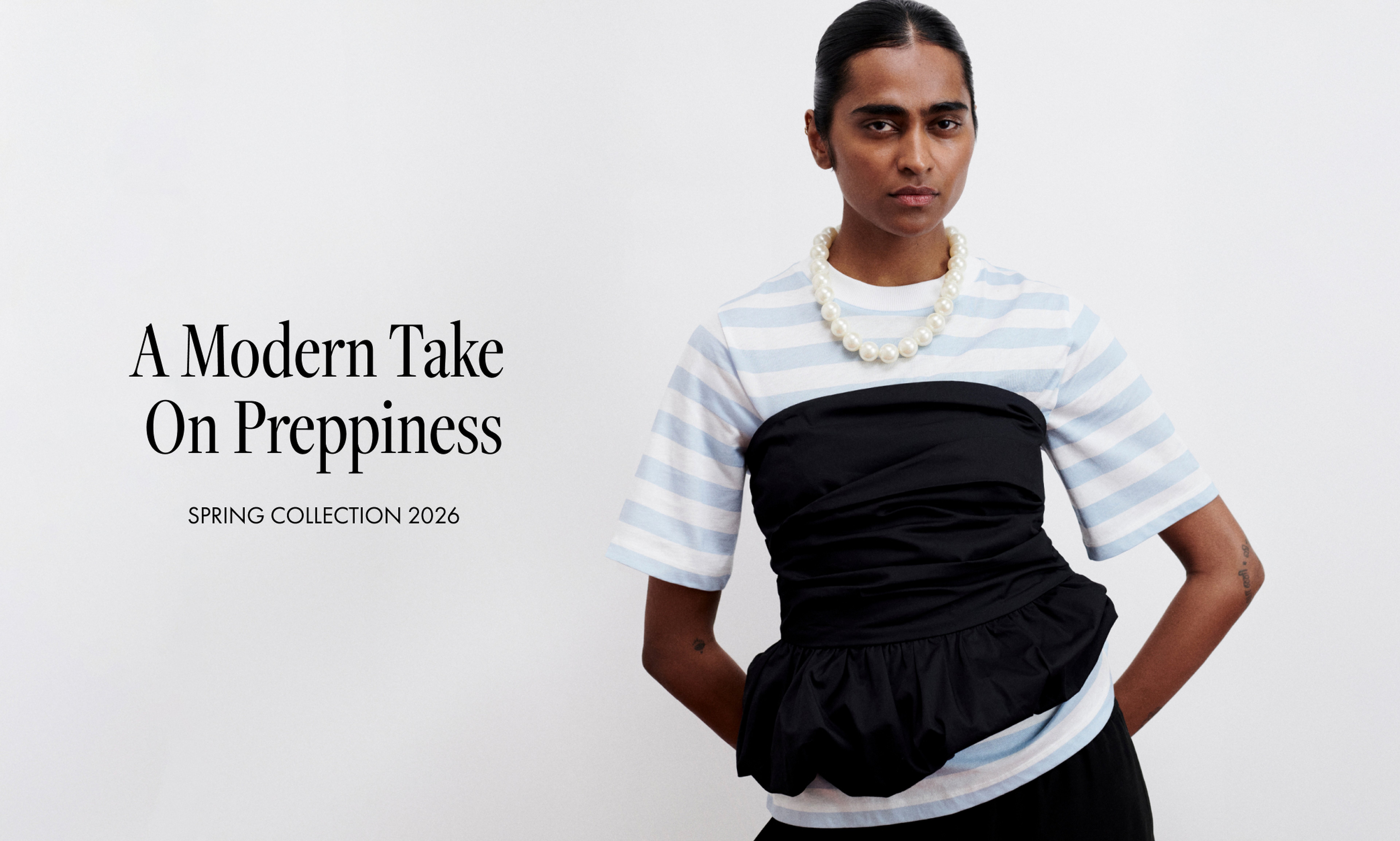 Model in striped top with pearl necklace, black cinched overlay; text reads "A Modern Take On Preppiness, Spring Collection 2026."