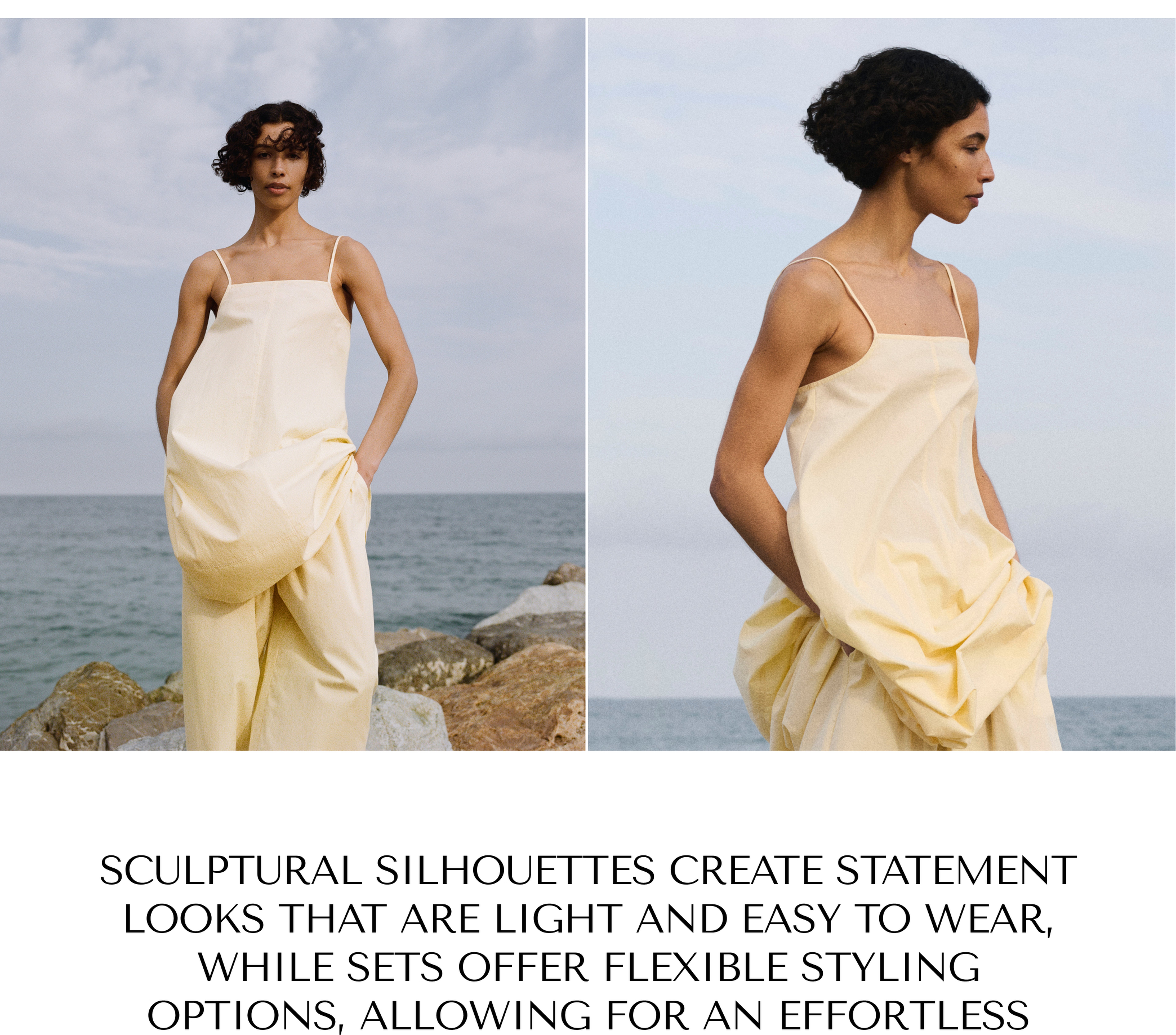 A person in a pale yellow, flowing dress stands near rocks by the ocean, with a cloudy sky above.