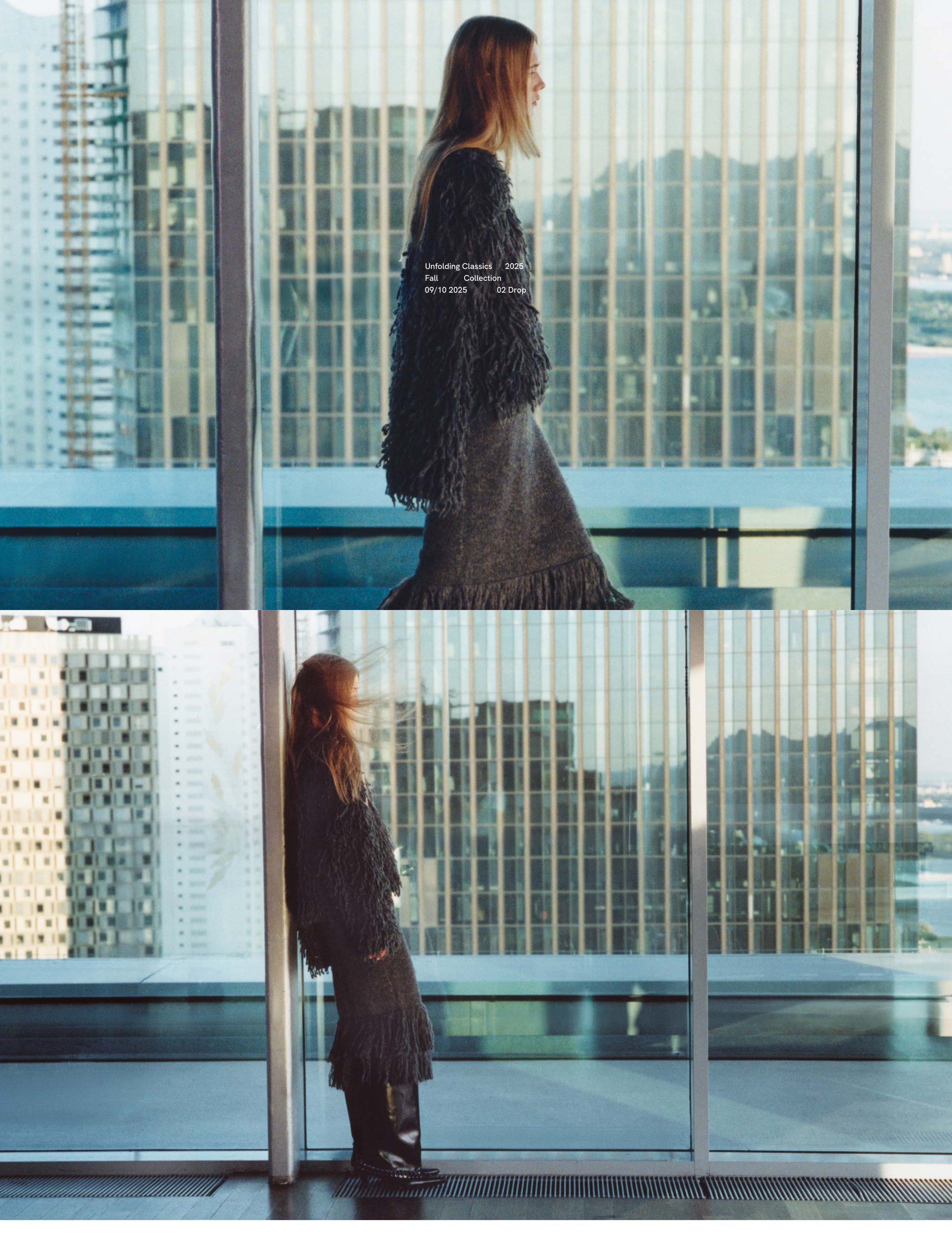 Woman in a dark, textured outfit stands by a large window, overlooking a cityscape with tall buildings in the background.