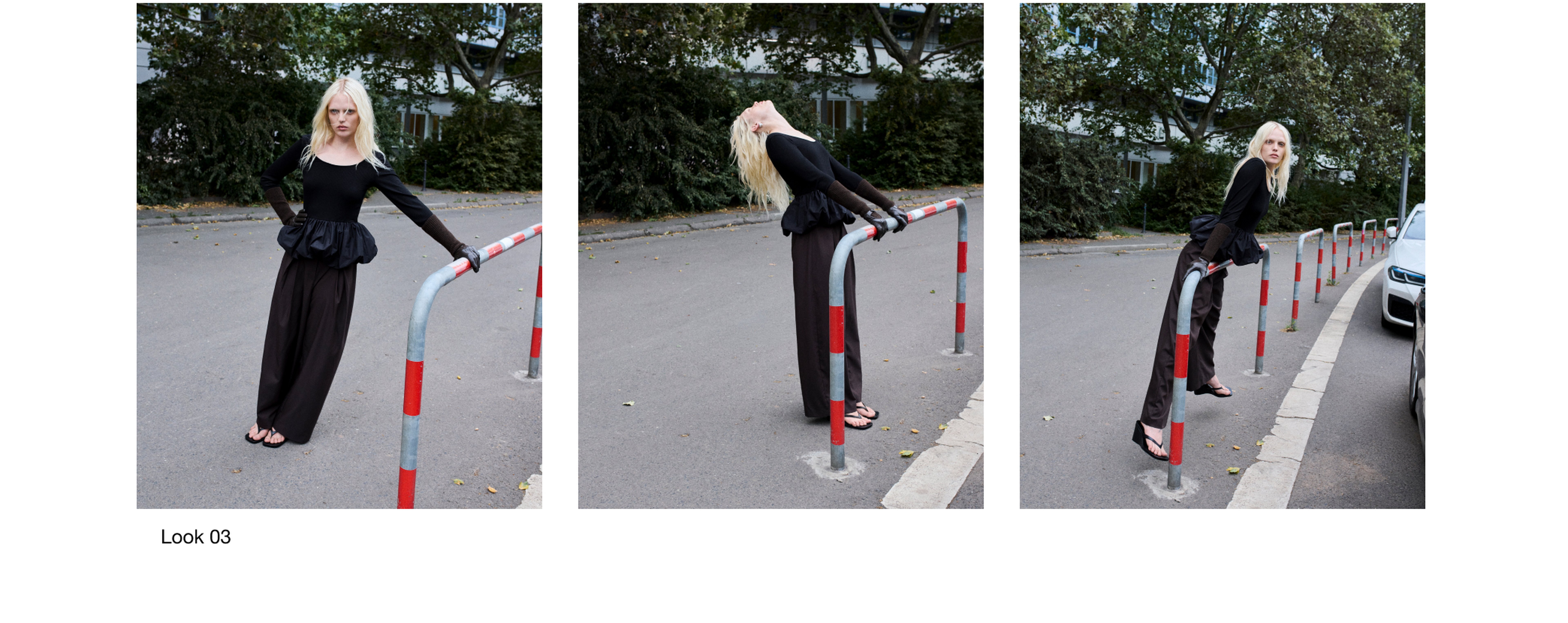 A person with long blonde hair poses in various ways on a street next to a curved red and gray metal barrier, wearing a black outfit and sandals.