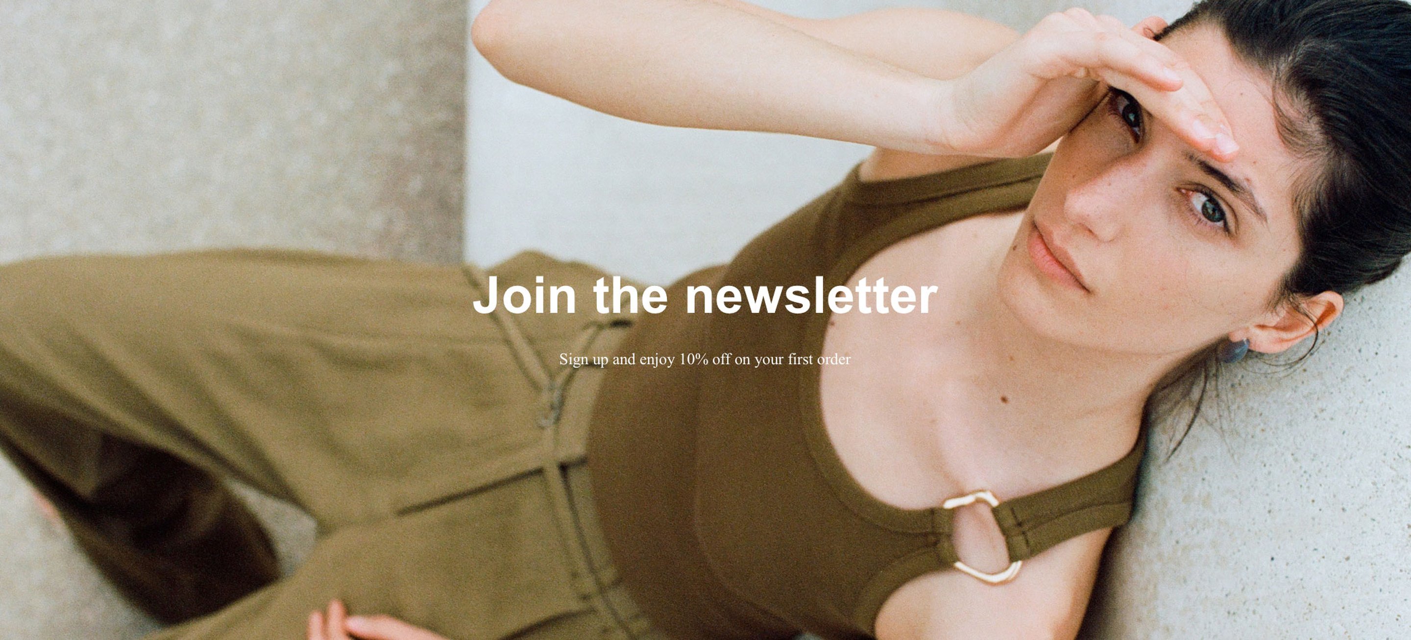 Woman in brown outfit sitting against a wall, shielding eyes with hand. Text reads "Join the newsletter" with a discount offer.