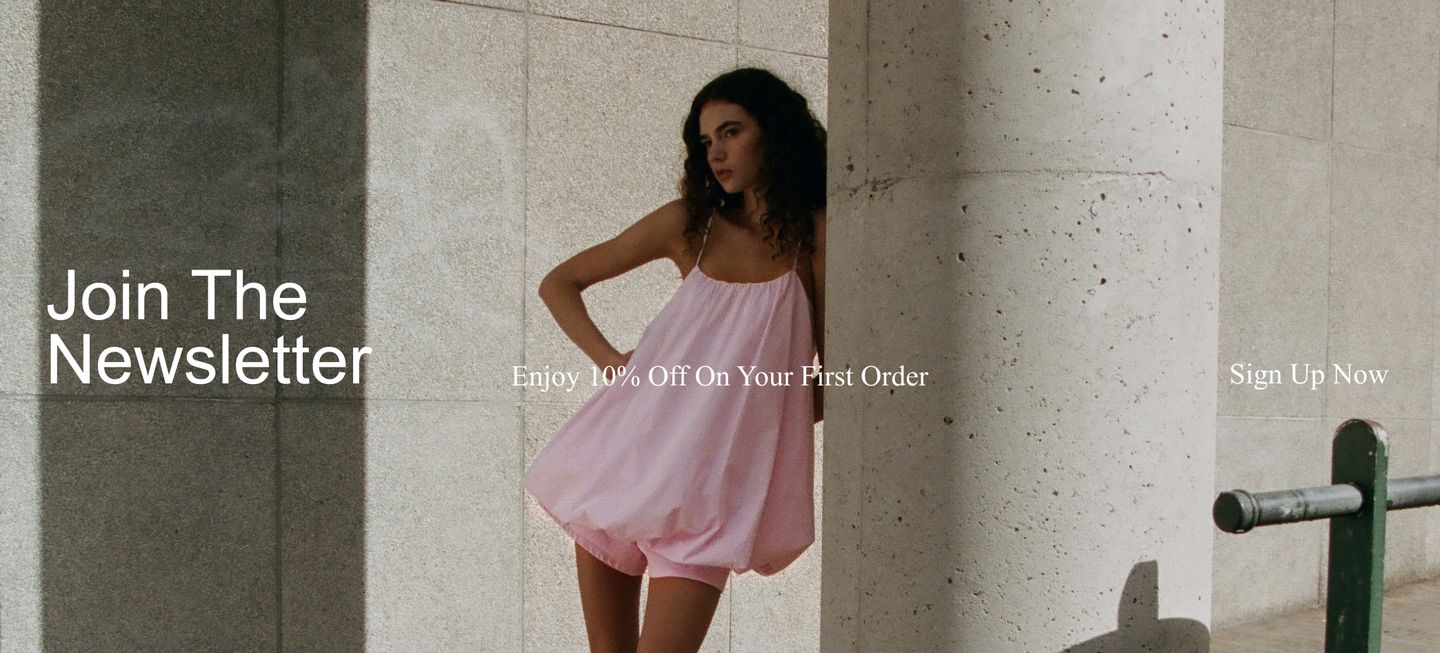 Woman in a pink dress leans against a stone column, with text: "Join The Newsletter," "Enjoy 10% Off On Your First Order," "Sign Up Now."