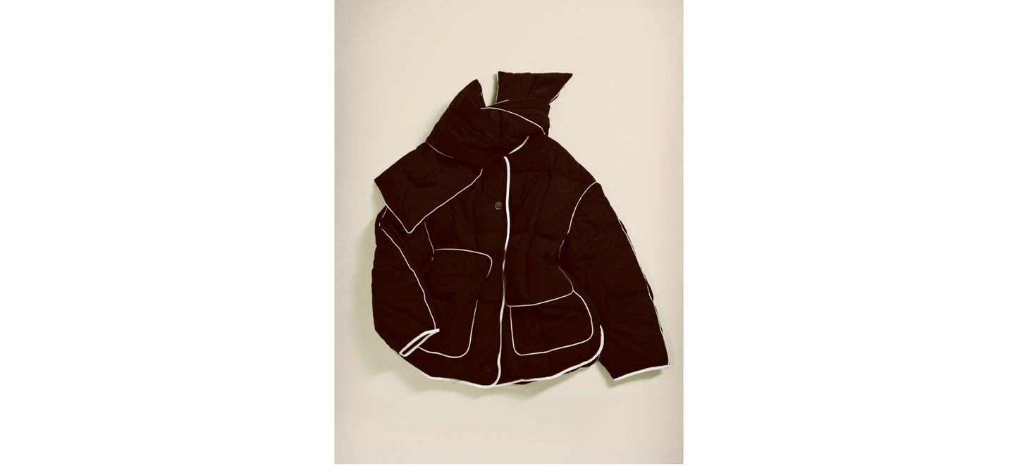 Black puffer jacket with white piping, featuring multiple pockets, displayed against a light background.