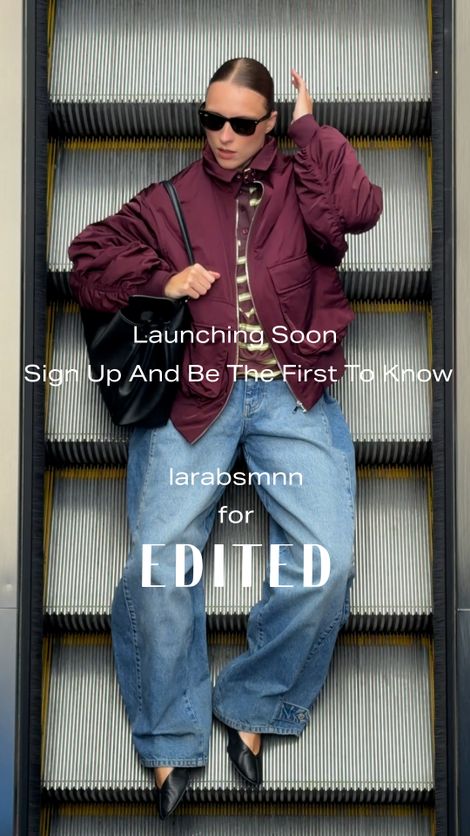 A woman in a burgundy jacket and jeans, wearing sunglasses, stands on an escalator with text overlay about an upcoming launch.