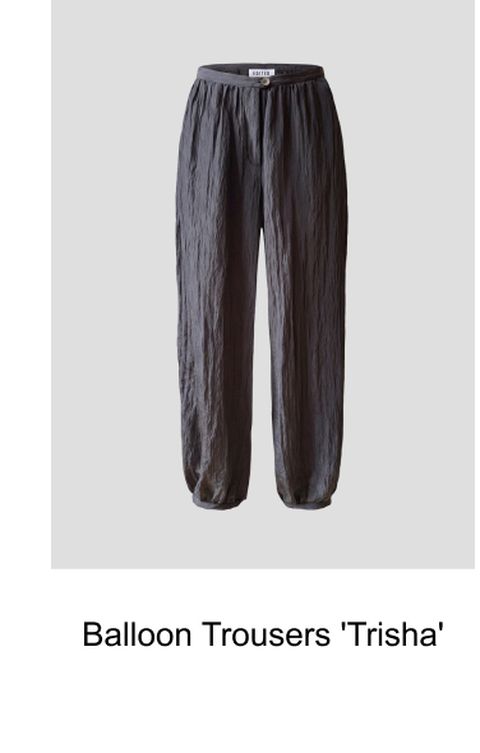 Dark gray crinkled balloon trousers with an elastic waistband and cuffed hems, labeled "Trisha."