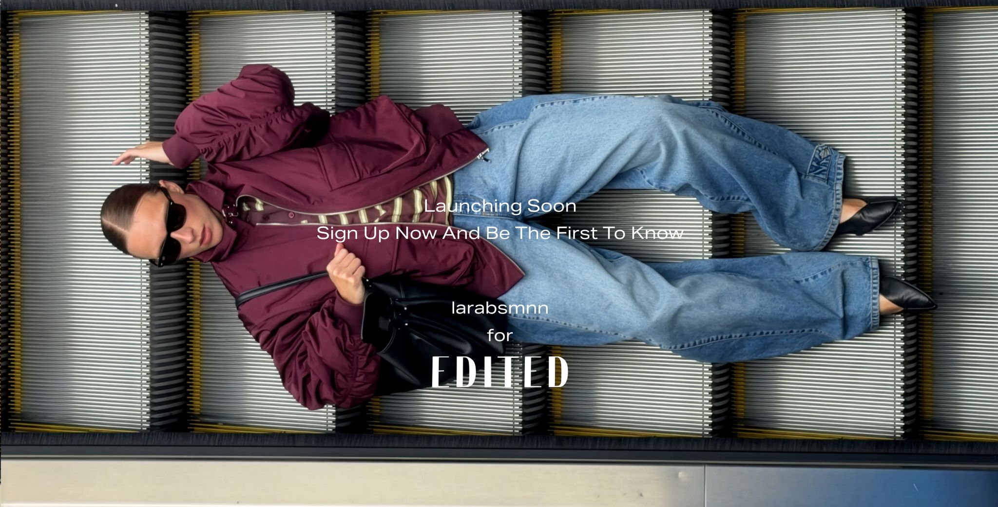 A person in sunglasses and a maroon jacket lies on an escalator, with text promoting a fashion launch by "larabsmnn" for "EDITED."