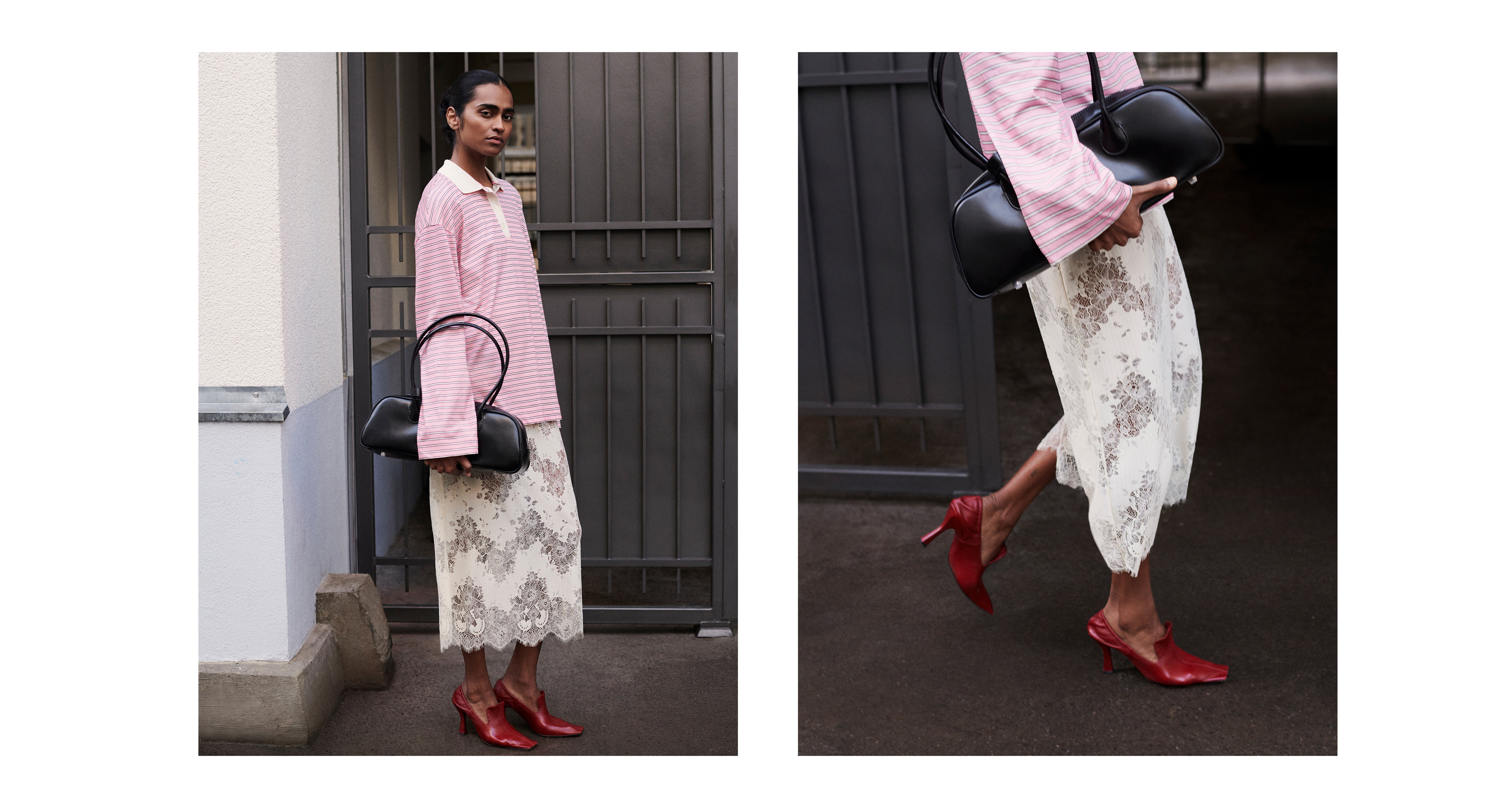 Woman in pink striped jacket and lace skirt holding a black handbag, wearing red heels, standing in front of a gate.