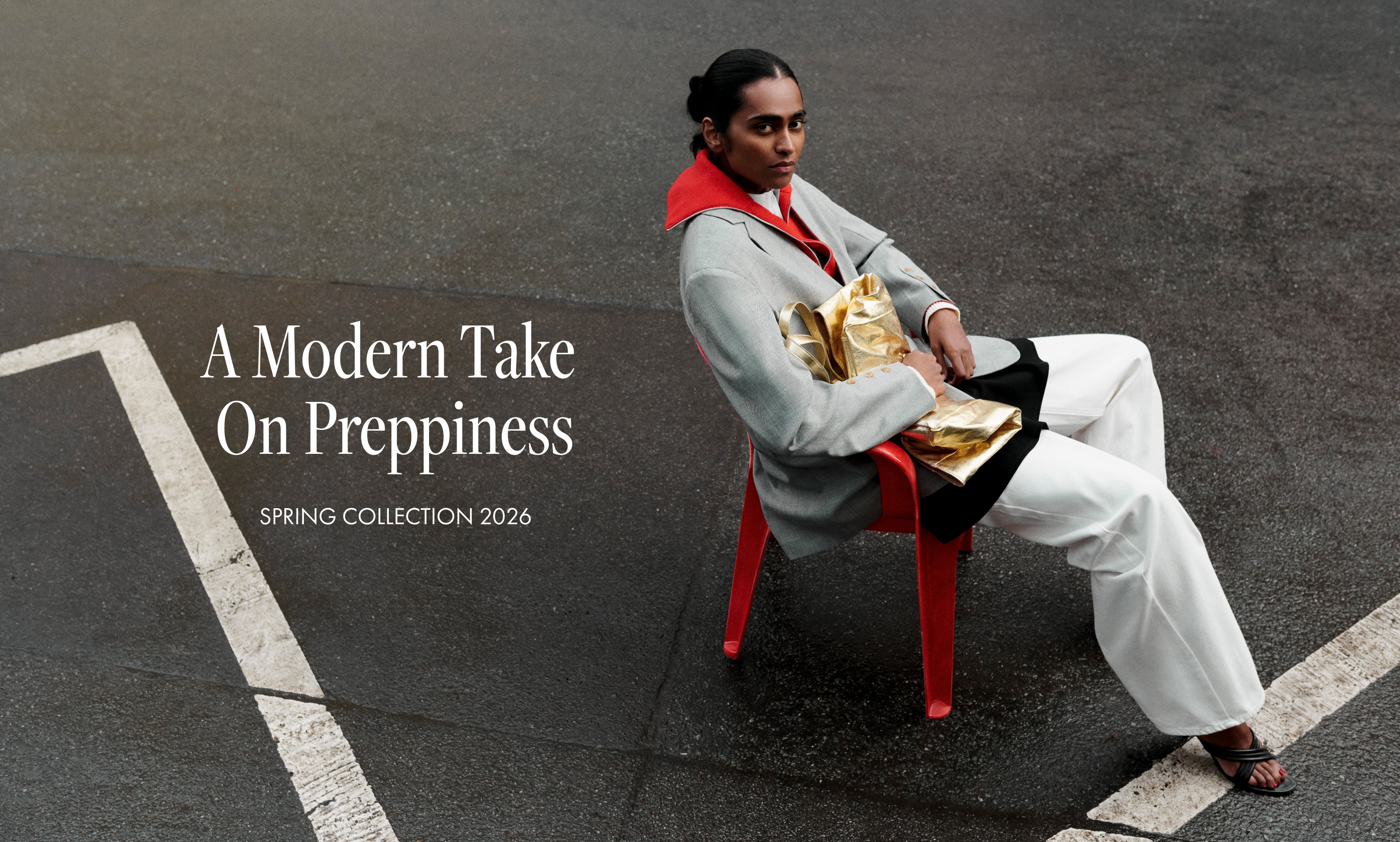 Person sitting on a red chair in stylish attire with a gold bag. Text reads "A Modern Take on Preppiness, Spring Collection 2026."