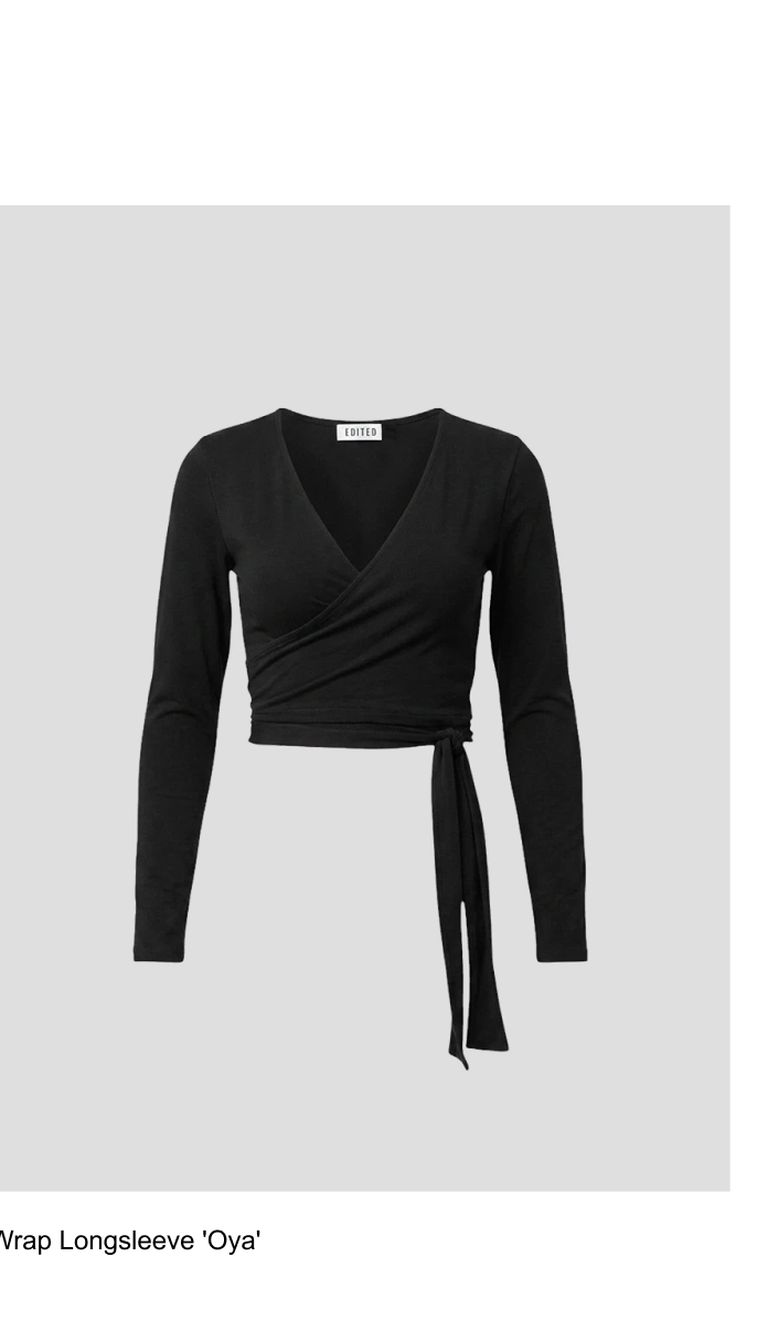 Black wrap long-sleeve top with V-neck and tie detail on the side, set against a plain gray background.