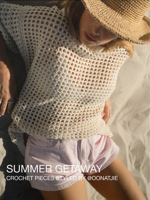 Woman in a straw hat and crochet top relaxing on the sand, styled in light pink shorts. Text reads "Summer Getaway, Crochet pieces styled by @oonatjie".