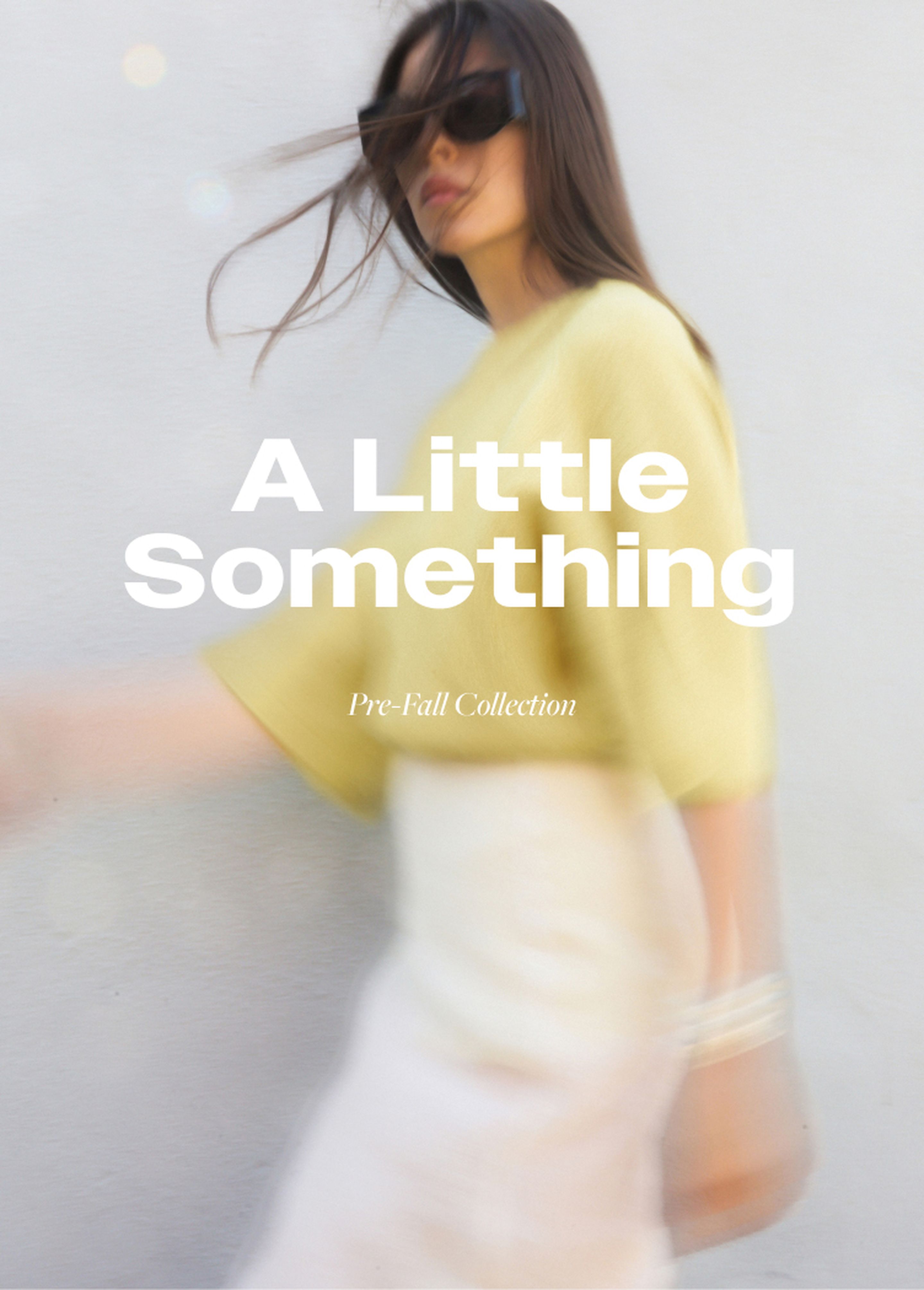 Woman in a yellow sweater and white skirt, wearing sunglasses, with blurred motion effect. Text: "A Little Something, Pre-Fall Collection."