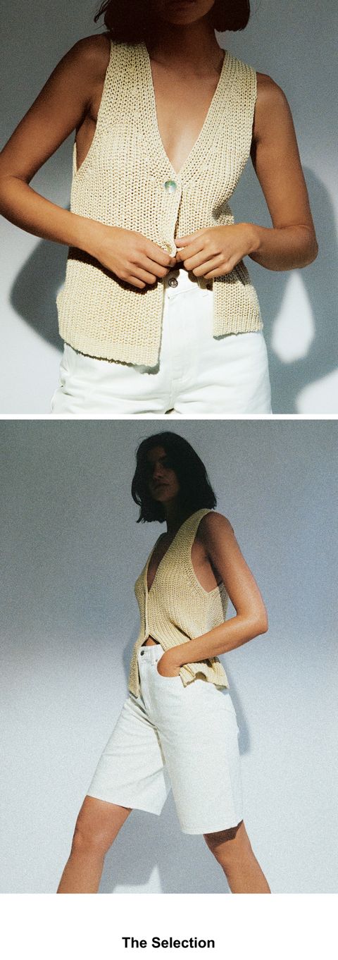 Person wearing a beige knit vest and light shorts, with hands at the waist, set against a minimal background.