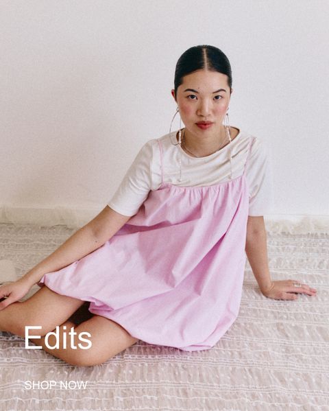 Woman in a pink dress sitting on a patterned rug, with "Edits" and "SHOP NOW" text overlayed.
