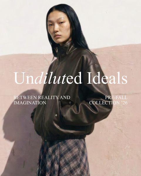 A person wearing a dark leather jacket and plaid skirt stands against a textured pink wall. Text reads "Undiluted Ideals," "Between Reality and Imagination," "Pre-Fall Collection '26."