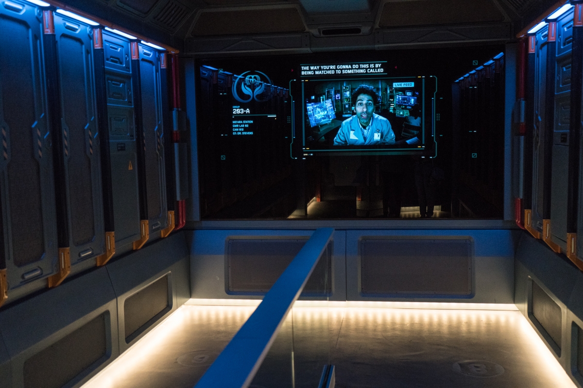 The decontamination room in Flight of Passage, a ride at Disney World, displays a man in a lab coat on the screen.