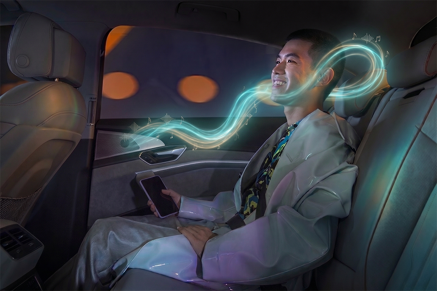 person in the backseat of the car with smartphone in the hand