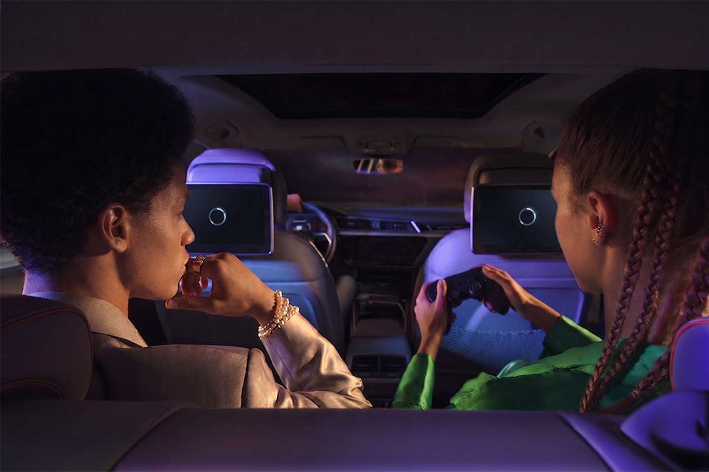 boy and girl sitting in the car playing games with headset on