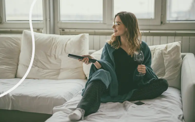 Kvinde streamer en film i sofaen