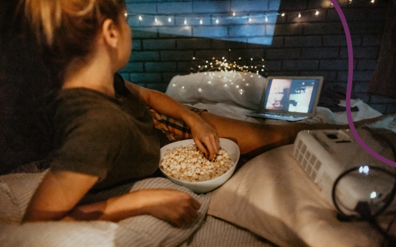 Kvinde streamer en film i sengen