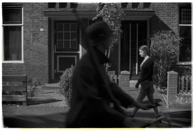 B&W two people walking passed eachother