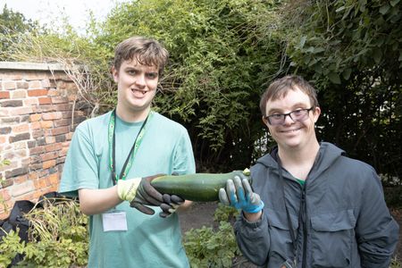 Gardening for wellbeing participants holding a courgette