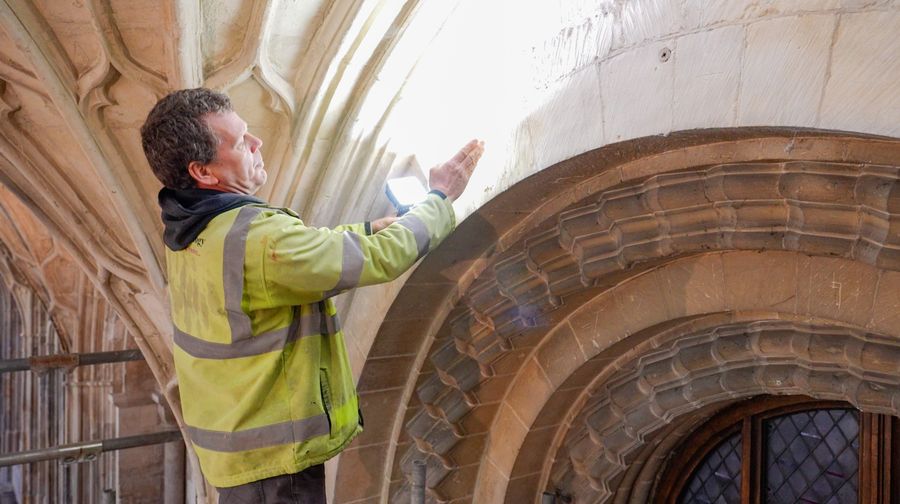 Chiz Harward archaeologist examining some stonework