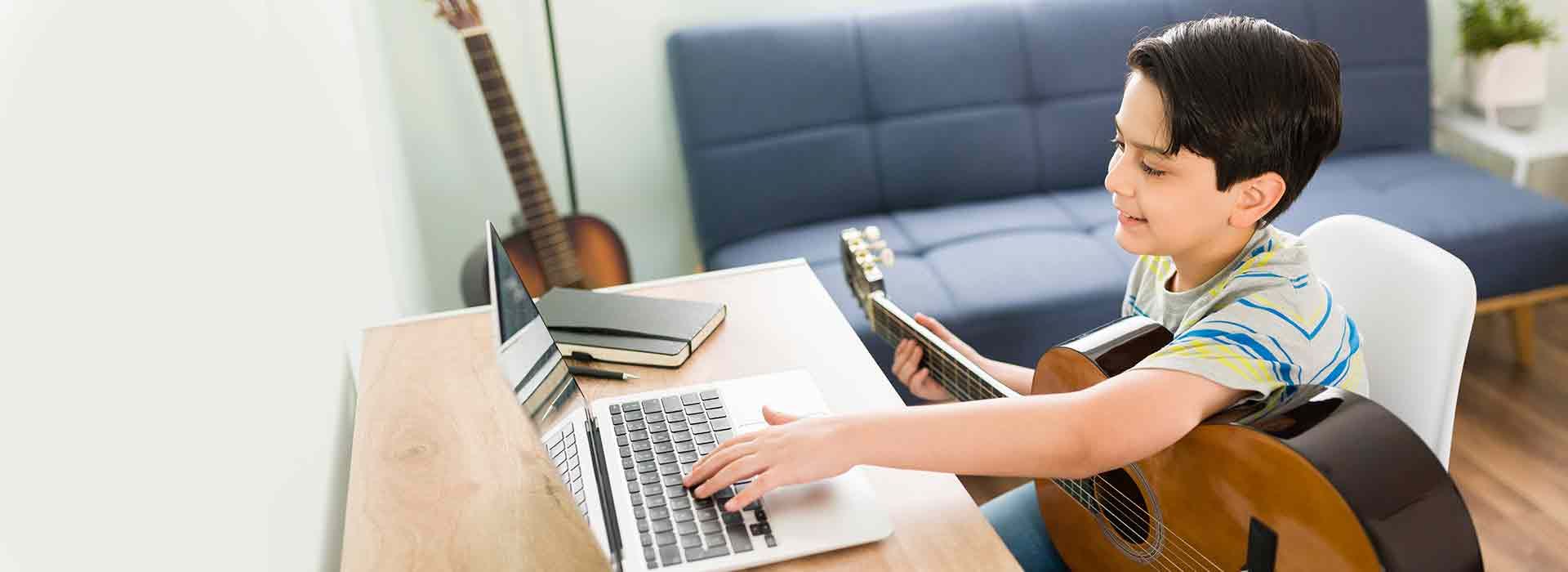 A boy learning guitar