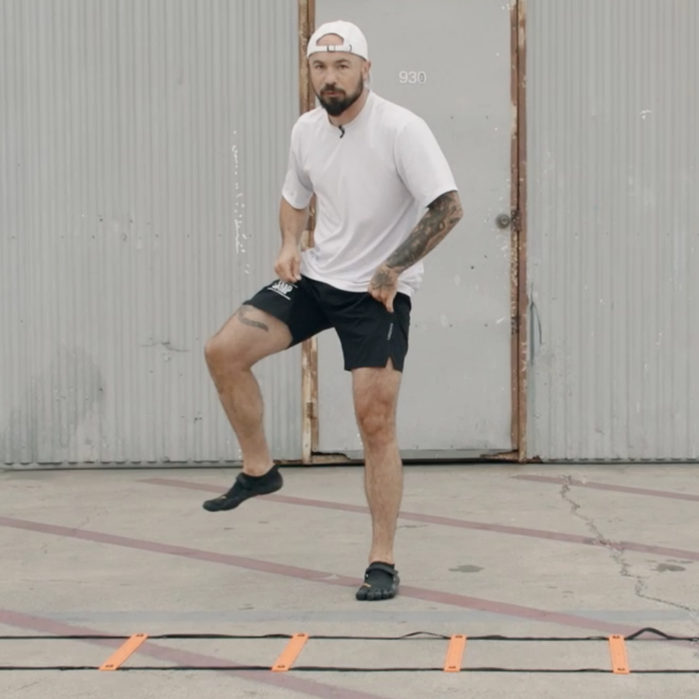 Aaron Swenson Doing a Hop Kick Agility Ladder Drill