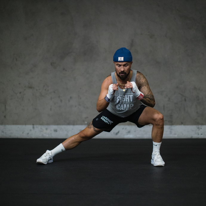 FightCamp Trainer Aaron Swenson Doing Side Lunges