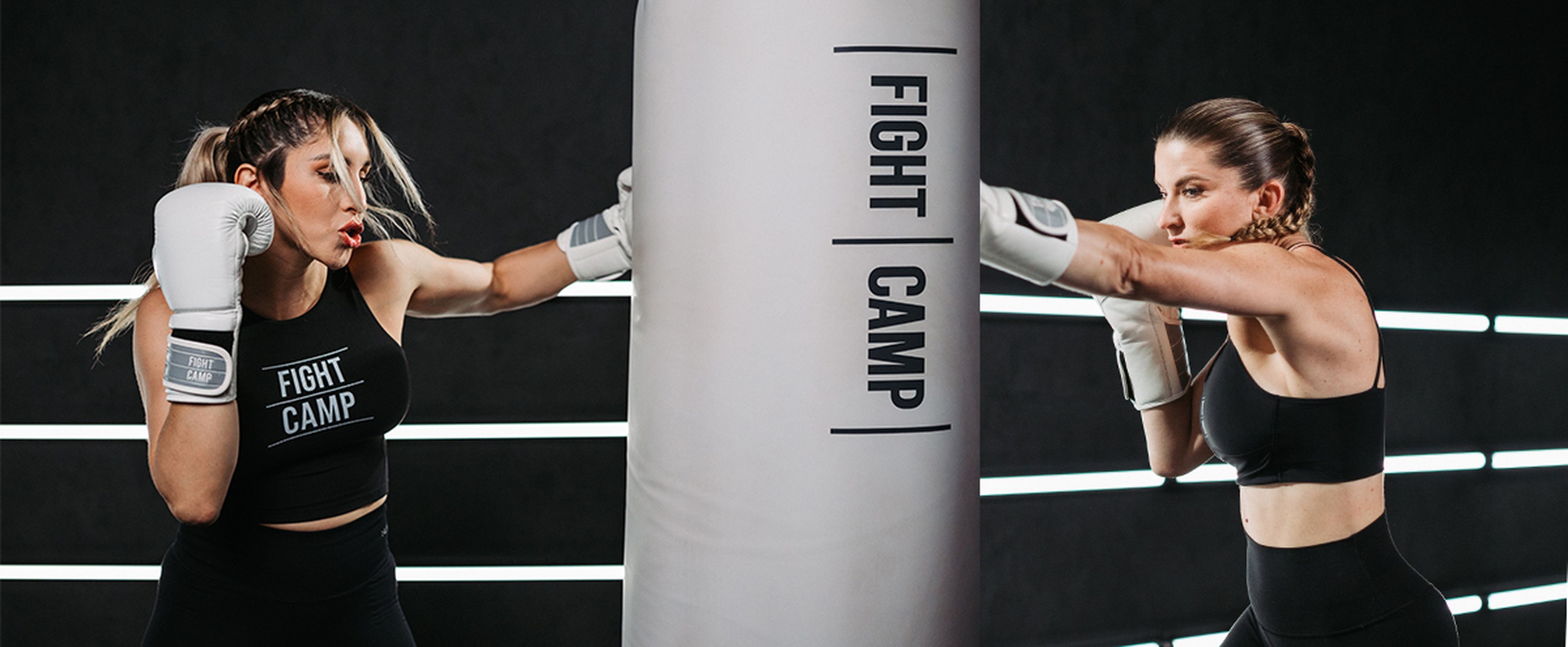 Coach Charlotte and Coach Selina punching FightCamp bag