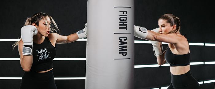 Coach Charlotte and Coach Selina punching FightCamp bag
