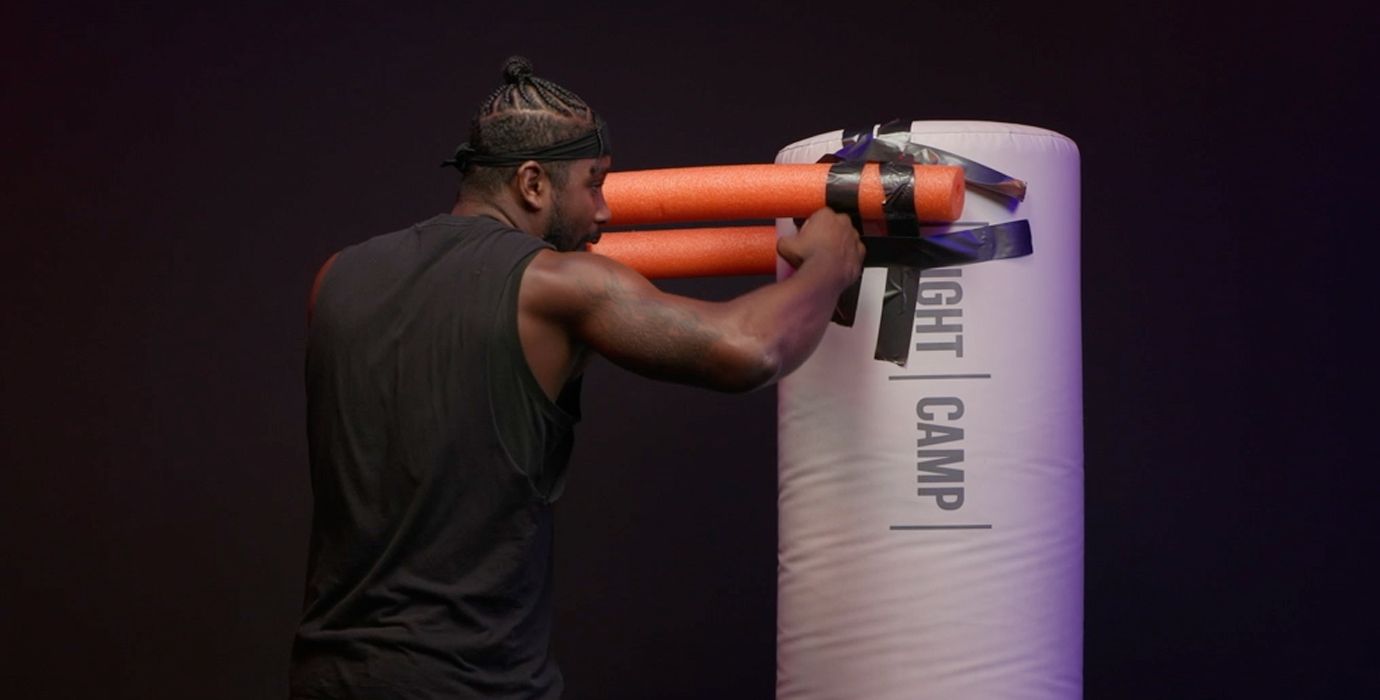 Coach PJ Throwing a Rear Hook on a Heavy Bag