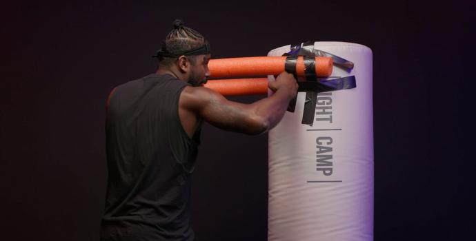Coach PJ Throwing a Rear Hook on a Heavy Bag