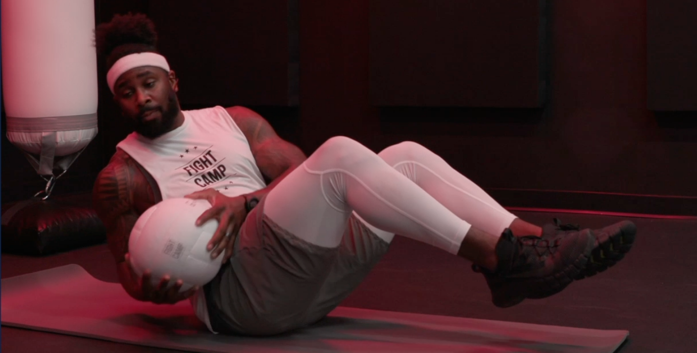 Coach PJ Doing Boxer Twists With a Medicine Ball