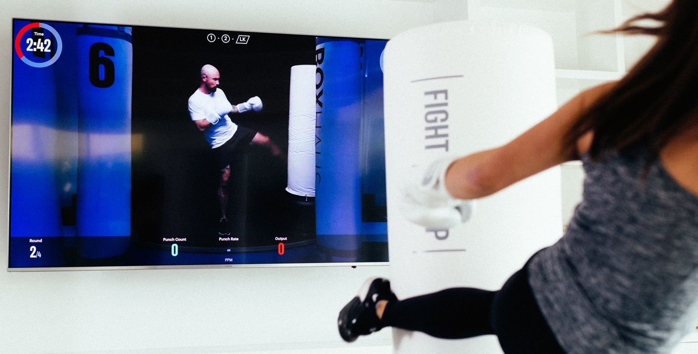 Boxer Kicking Heavy Bag During FightCamp Workout