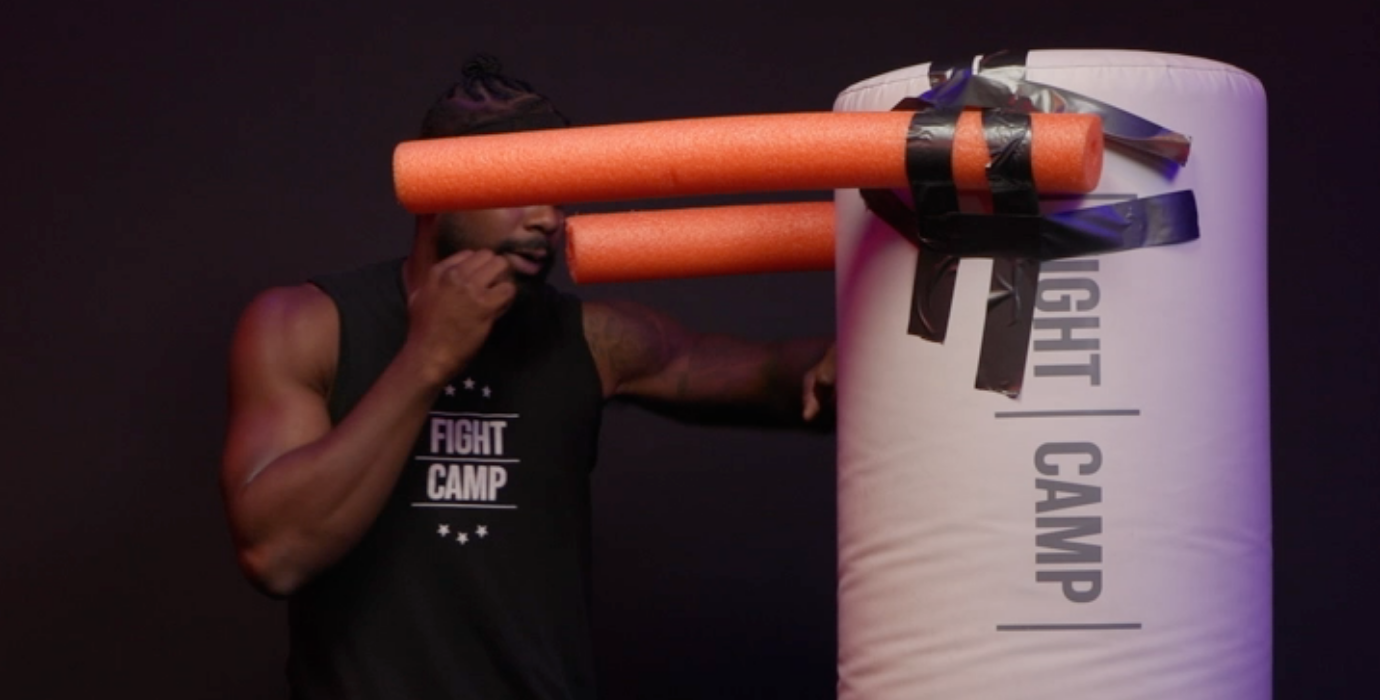 Coach PJ Doing a Lead Hook on a Punching Bag