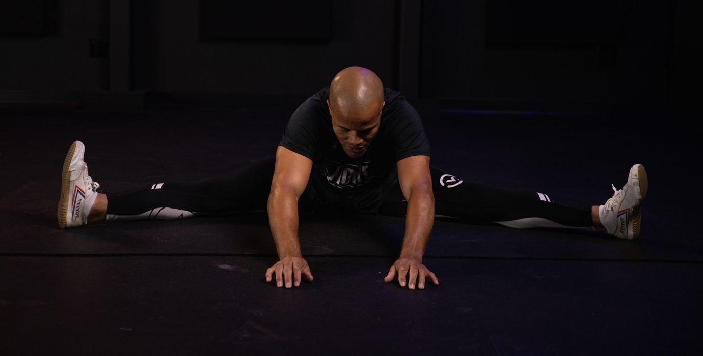 Flo Master Doing a Straddle Stretch