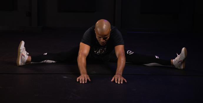Flo Master Doing a Straddle Stretch