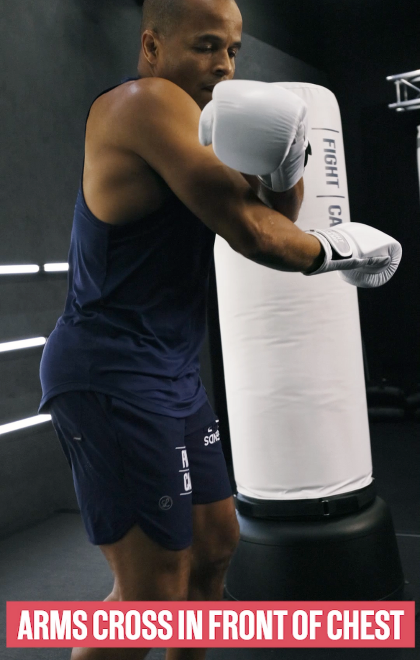 Arms cross in front of chest