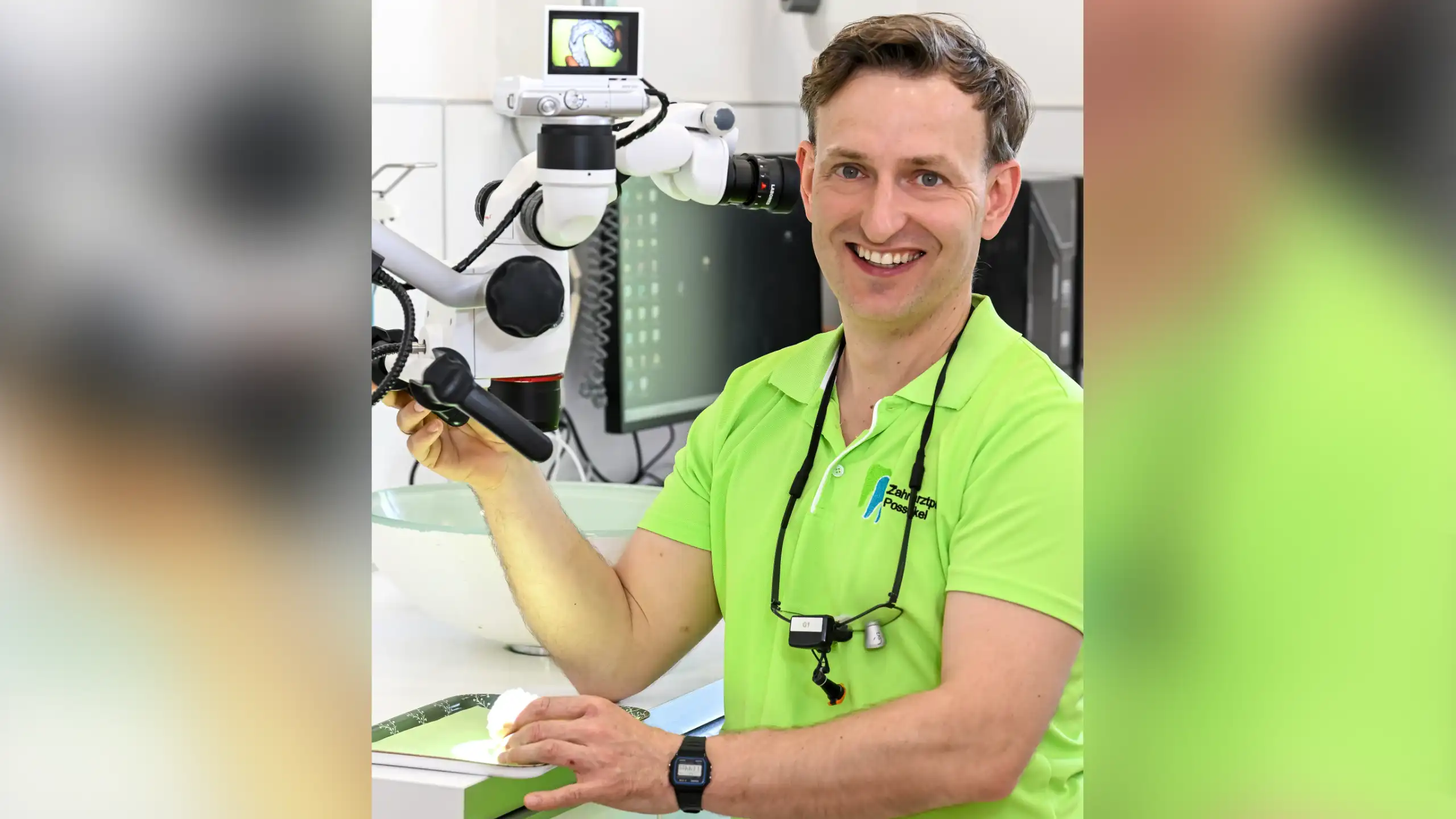 Georg Possekel in a green shirt holding a dental instrument beside a microscope in a dental office.